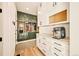 Hallway/Mud Room features a custom walk-in closet with high end finishes, and hardwood floors at 8378 Arapahoe Peak St, Littleton, CO 80125