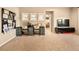 This room features a well-lit desk area with large windows and plush carpeting at 8378 Arapahoe Peak St, Littleton, CO 80125