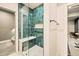 Modern tiled shower includes a built-in bench and glass door at 8378 Arapahoe Peak St, Littleton, CO 80125