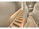 Carpeted staircase features modern lighting and neutral paint at 8378 Arapahoe Peak St, Littleton, CO 80125