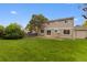 The spacious back yard boasts a large lawn, mature trees, and privacy fence at 4650 S Idalia St, Aurora, CO 80015