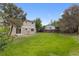 The large back yard features an expansive lawn, mature trees and privacy fence at 4650 S Idalia St, Aurora, CO 80015
