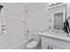 All-white bathroom featuring a tiled shower-tub, toilet, and a vanity with a countertop at 4650 S Idalia St, Aurora, CO 80015