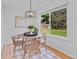 Dining room with natural light, views to the yard and stylish modern chandelier at 4650 S Idalia St, Aurora, CO 80015