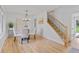 Bright dining room with a modern chandelier and views to the stairs at 4650 S Idalia St, Aurora, CO 80015