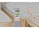 Hallway featuring hardwood floors, stairs, and views of the backyard at 4650 S Idalia St, Aurora, CO 80015