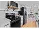 Modern kitchen with white cabinets, quartz countertops, and stainless steel appliances at 4650 S Idalia St, Aurora, CO 80015