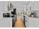Modern kitchen with white cabinets, quartz countertops, and stainless steel appliances at 4650 S Idalia St, Aurora, CO 80015