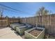This backyard features raised garden beds and a wood fence at 4648 Josephine St, Denver, CO 80216