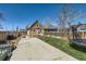 Large backyard features a concrete patio, wood fence, and some grass at 4648 Josephine St, Denver, CO 80216