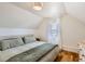 Attic bedroom with wood floors, a large bed, and natural light from the window at 4648 Josephine St, Denver, CO 80216