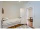 Well-lit bedroom with hardwood floors and a trundle bed, next to an open doorway at 4648 Josephine St, Denver, CO 80216