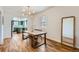 Bright dining room featuring hardwood floors, a dining table, and a view into the modern kitchen at 4648 Josephine St, Denver, CO 80216