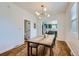 Comfortable dining room featuring hardwood floors, a dining table, and a view into the modern kitchen at 4648 Josephine St, Denver, CO 80216