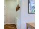Bright hallway with sleek white storage unit, coat rack, and hardwood floors at 4648 Josephine St, Denver, CO 80216
