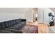 Cozy attic living area with modern sofa and doorways to bedrooms and a gym at 4648 Josephine St, Denver, CO 80216