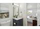 Bathroom with vanity, toilet, decor and a glimpse into bedroom at 1330 Oak Pl, Thornton, CO 80229