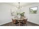 Charming dining area featuring a glass table, designer lighting, and stylish decor for an inviting atmosphere at 1330 Oak Pl, Thornton, CO 80229