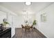 Bright dining area with a modern light fixture, creating a welcoming space for Gathering meals and entertaining guests at 1330 Oak Pl, Thornton, CO 80229