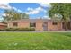 Charming brick ranch home with a well-maintained lawn, mature trees, and a cozy, inviting curb appeal at 1330 Oak Pl, Thornton, CO 80229