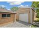 Detached garage with white door and gravel at 1330 Oak Pl, Thornton, CO 80229