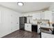 Well-equipped kitchen with white cabinetry and sleek appliances, providing a functional and stylish cooking environment at 1330 Oak Pl, Thornton, CO 80229