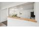 Bright kitchen features white cabinets, stainless steel appliances, and an open view to the adjacent dining area at 1330 Oak Pl, Thornton, CO 80229