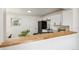 Modern kitchen with sleek countertops, white cabinetry, black appliances, and a cozy breakfast bar at 1330 Oak Pl, Thornton, CO 80229