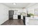 Bright kitchen with white cabinets, stainless steel appliances, and sleek countertops, designed for modern living at 1330 Oak Pl, Thornton, CO 80229