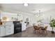 An open concept connecting the kitchen to the dining area, with new floors and natural light at 1330 Oak Pl, Thornton, CO 80229