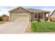 Inviting single-story home featuring a well-kept lawn, concrete driveway, and attached two-car garage at 848 Sagebrush Dr, Brighton, CO 80603