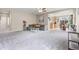 Open-concept living room featuring plush gray carpet and seamless flow into the adjacent dining area at 848 Sagebrush Dr, Brighton, CO 80603