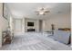 Bright living room with neutral walls, carpet floors, ceiling fan, and modern decor at 848 Sagebrush Dr, Brighton, CO 80603