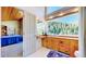 Bright bathroom with wood cabinets, mountain views, and doorway to bedroom at 2602 Hidden Valley Road, Sedalia, CO 80135