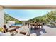 Expansive deck with a hot tub, dining area, and stunning views of the surrounding landscape at 2602 Hidden Valley Road, Sedalia, CO 80135