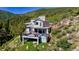 View of the deck with a hot tub and views of the mountains at 2602 Hidden Valley Road, Sedalia, CO 80135
