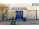 Charming entryway with a covered porch, a blue front door and flower pots at 2602 Hidden Valley Road, Sedalia, CO 80135