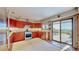 Eat-in kitchen with light countertops and stainless steel appliances opens to a sunroom at 2602 Hidden Valley Road, Sedalia, CO 80135