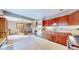 View of the kitchen and dining area with a stainless steel refrigerator at 2602 Hidden Valley Road, Sedalia, CO 80135