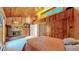 Bedroom boasts wood paneled walls, fireplace, and ample storage at 2602 Hidden Valley Road, Sedalia, CO 80135