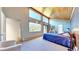 Primary bedroom with wood ceiling, mountain views, and access to balcony at 2602 Hidden Valley Road, Sedalia, CO 80135