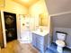 A clean and modern bathroom with glass shower, vanity, and a stacked washer/dryer combo at 1520 Virginia St, Idaho Springs, CO 80452
