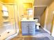 This modern bathroom features a glass enclosed shower and vanity with gray cabinets at 1520 Virginia St, Idaho Springs, CO 80452