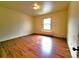 This bedroom features hardwood flooring, a window and a light to brighten the room at 1520 Virginia St, Idaho Springs, CO 80452