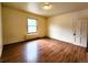 This bedroom features hardwood flooring, a window and a light to brighten the room at 1520 Virginia St, Idaho Springs, CO 80452