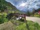 A foot bridge that crosses over a rushing mountain stream in a forested area at 1520 Virginia St, Idaho Springs, CO 80452