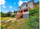 Charming two-story house with brick foundation and wood siding on a hillside lot at 1520 Virginia St, Idaho Springs, CO 80452