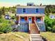 Two-story home with charming front porch sits on a hillside lot at 1520 Virginia St, Idaho Springs, CO 80452
