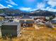 Two-story home with wood siding has mountain views, storage shed, and brick foundation at 1520 Virginia St, Idaho Springs, CO 80452