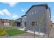 Modern two-story home featuring a well-maintained backyard with artificial turf, hardscape, and a basketball hoop at 9836 Banner Peak St, Littleton, CO 80125
